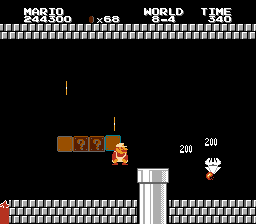 Mario duck jumping, hitting a coin block while also killing a Blooper